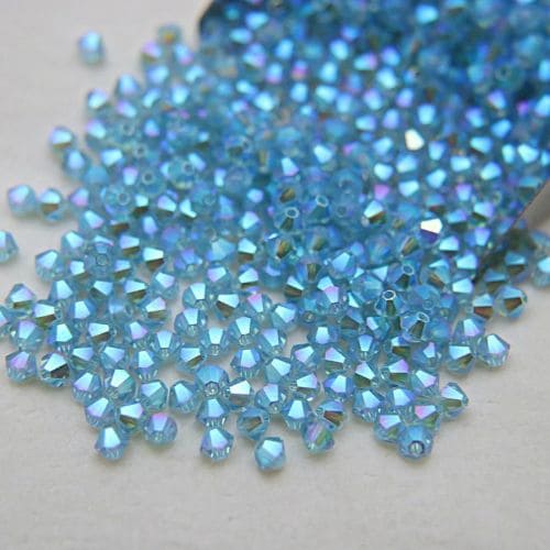 Shiny Swarovski beads in different colors and sizes for jewelry making and crafts.